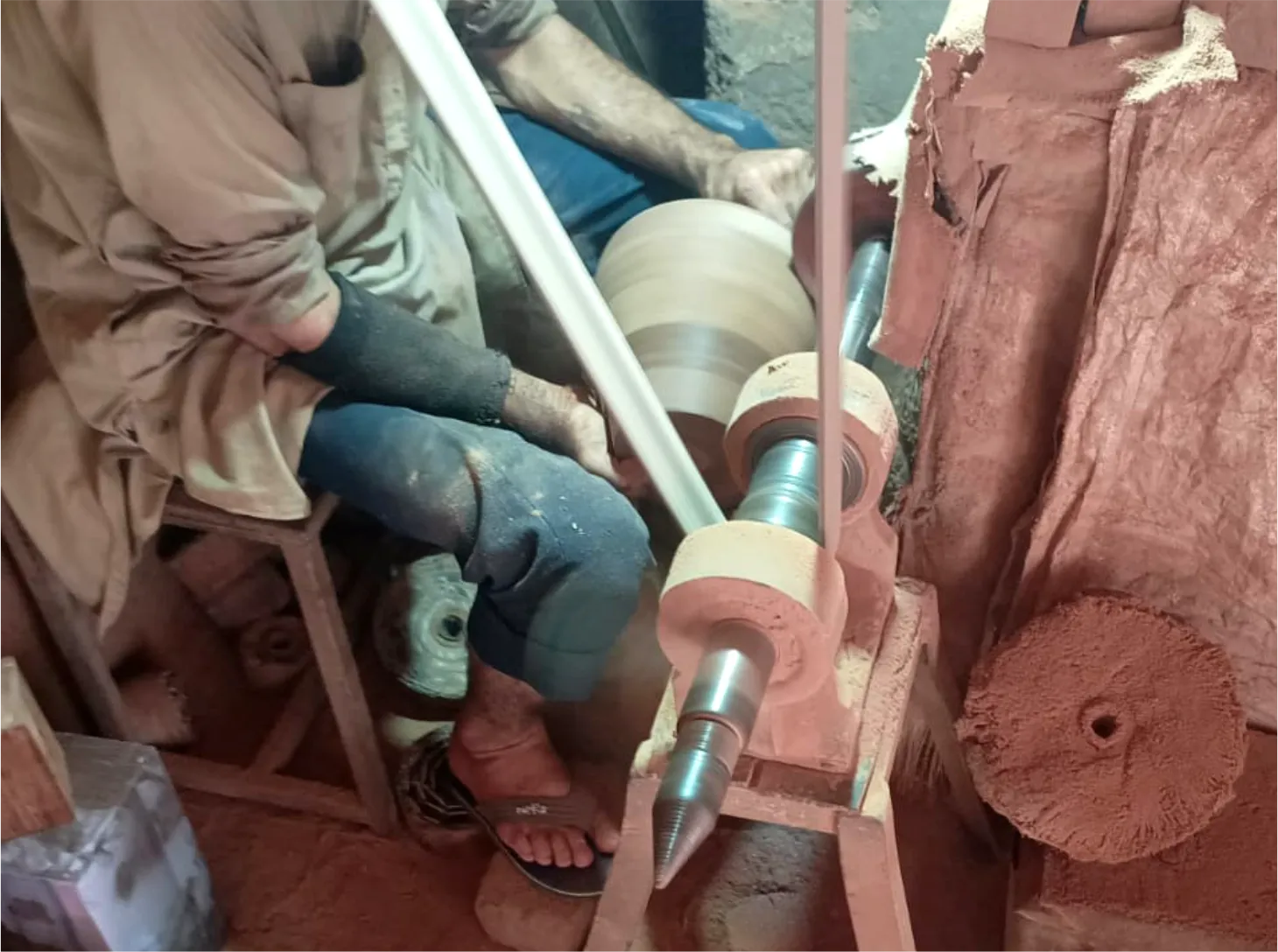 Artisan turning a component on a traditional lathe