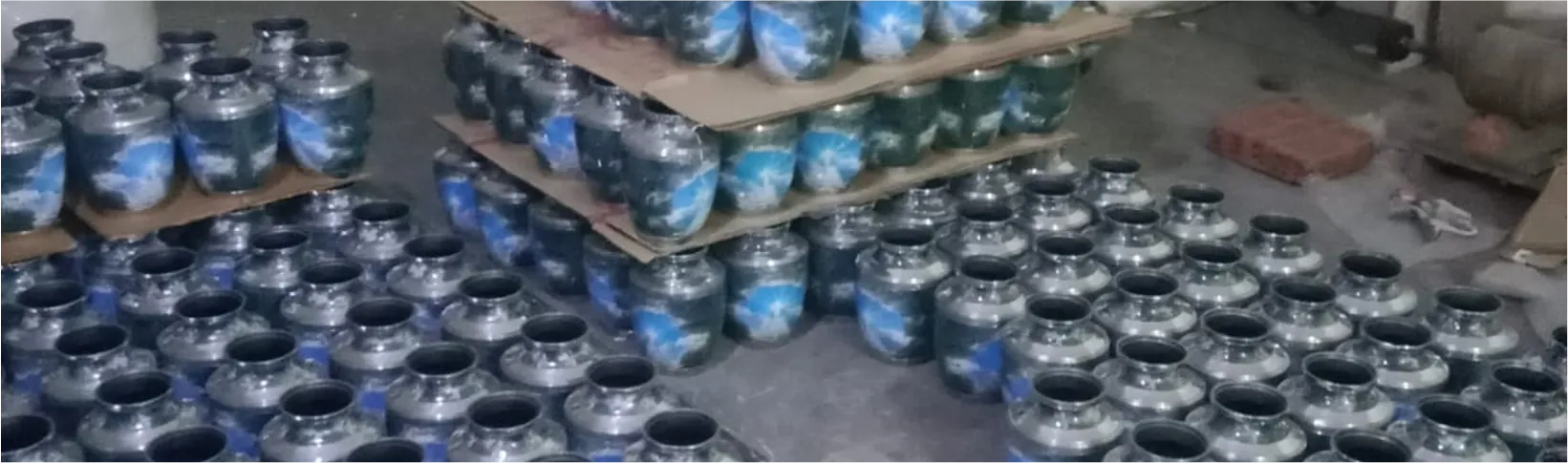 Blue enamel cremation urns stacked on shelves