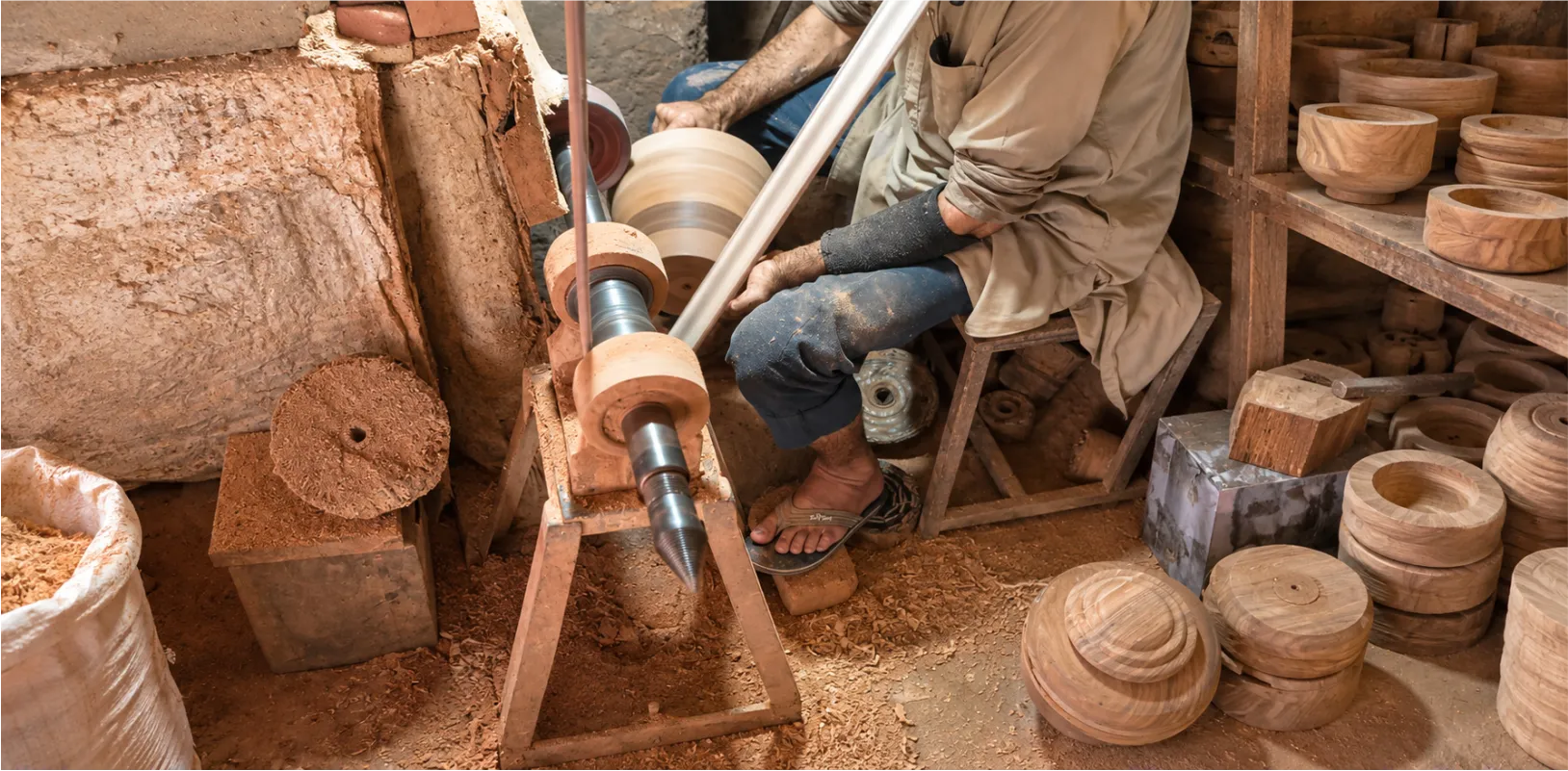 Woodturner shaping wooden pieces on a lathe